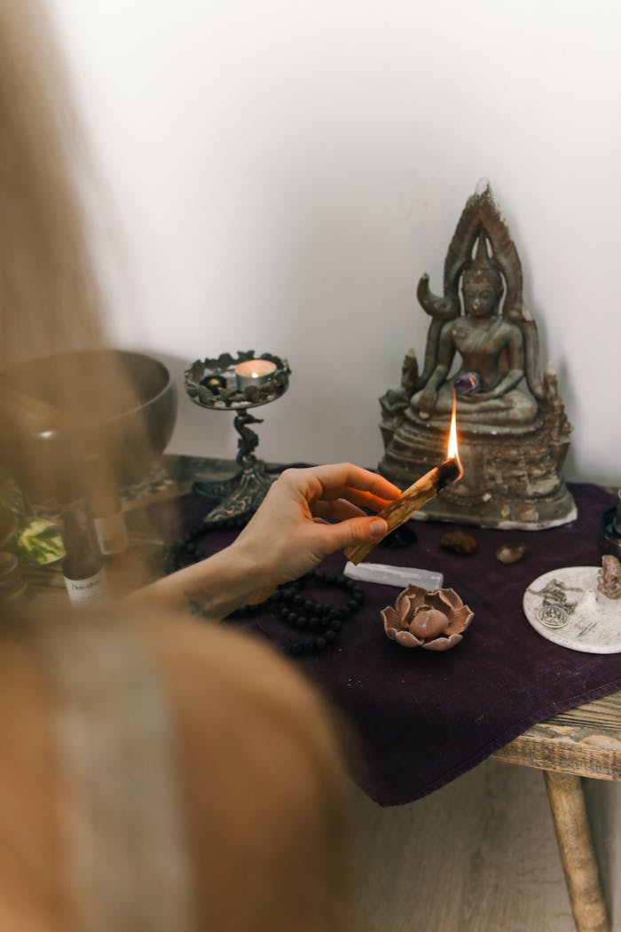 Mastering the First Impression: Your intriguing post title goes here A serene spiritual setup with sage burning beside a Buddha statue, promoting calm and meditation.