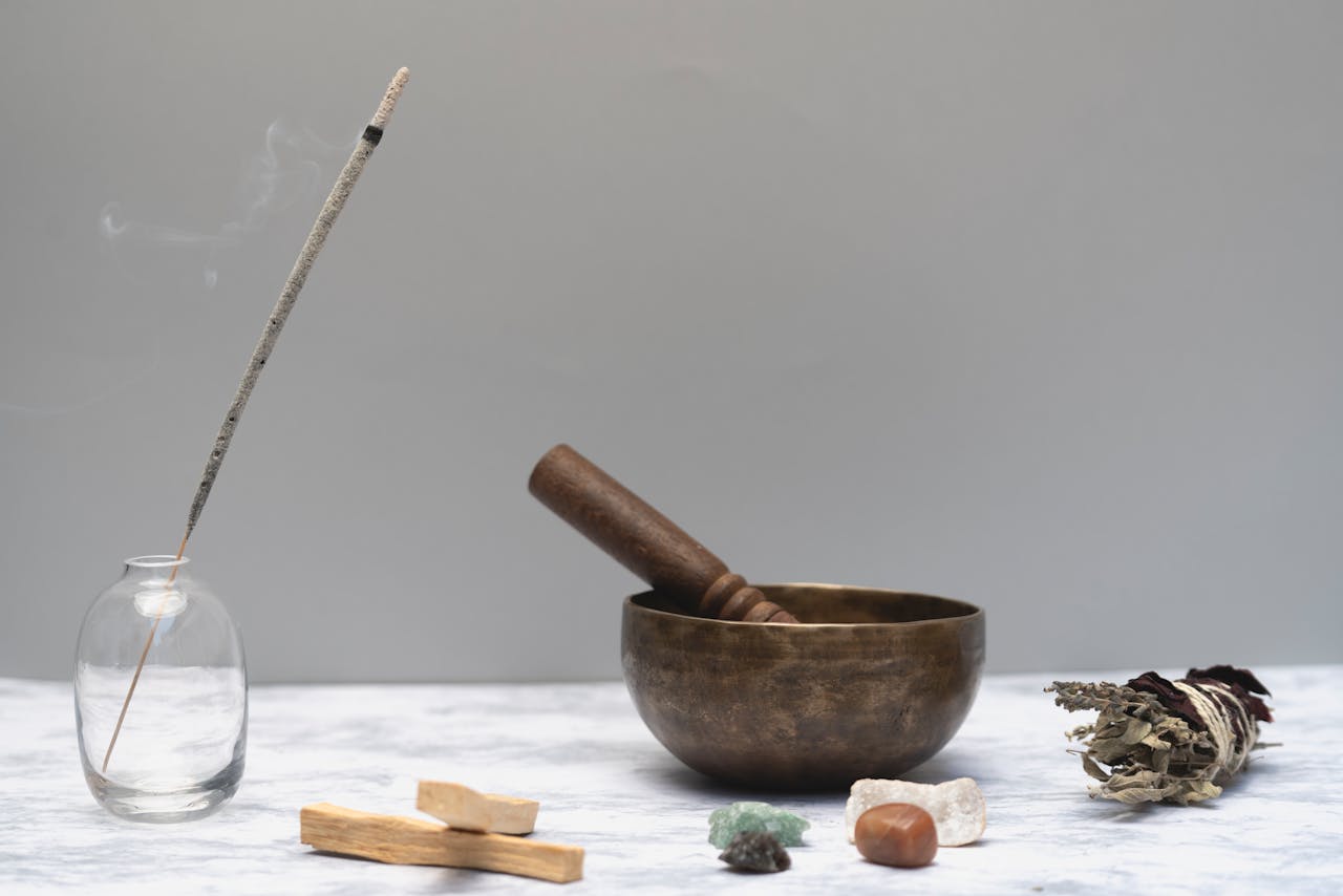 Crafting Captivating Headlines: Your awesome post title goes here Arrangement of spiritual healing items including incense, bowl, sage, and gemstones on a marble surface.